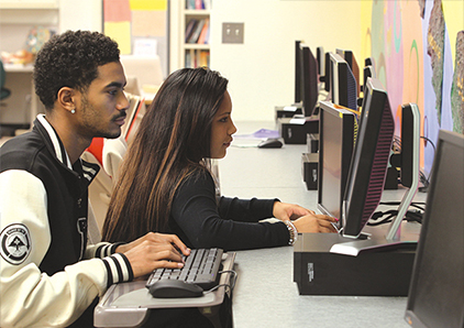 Two students working at computer in the Access and Disability Resource Center.
