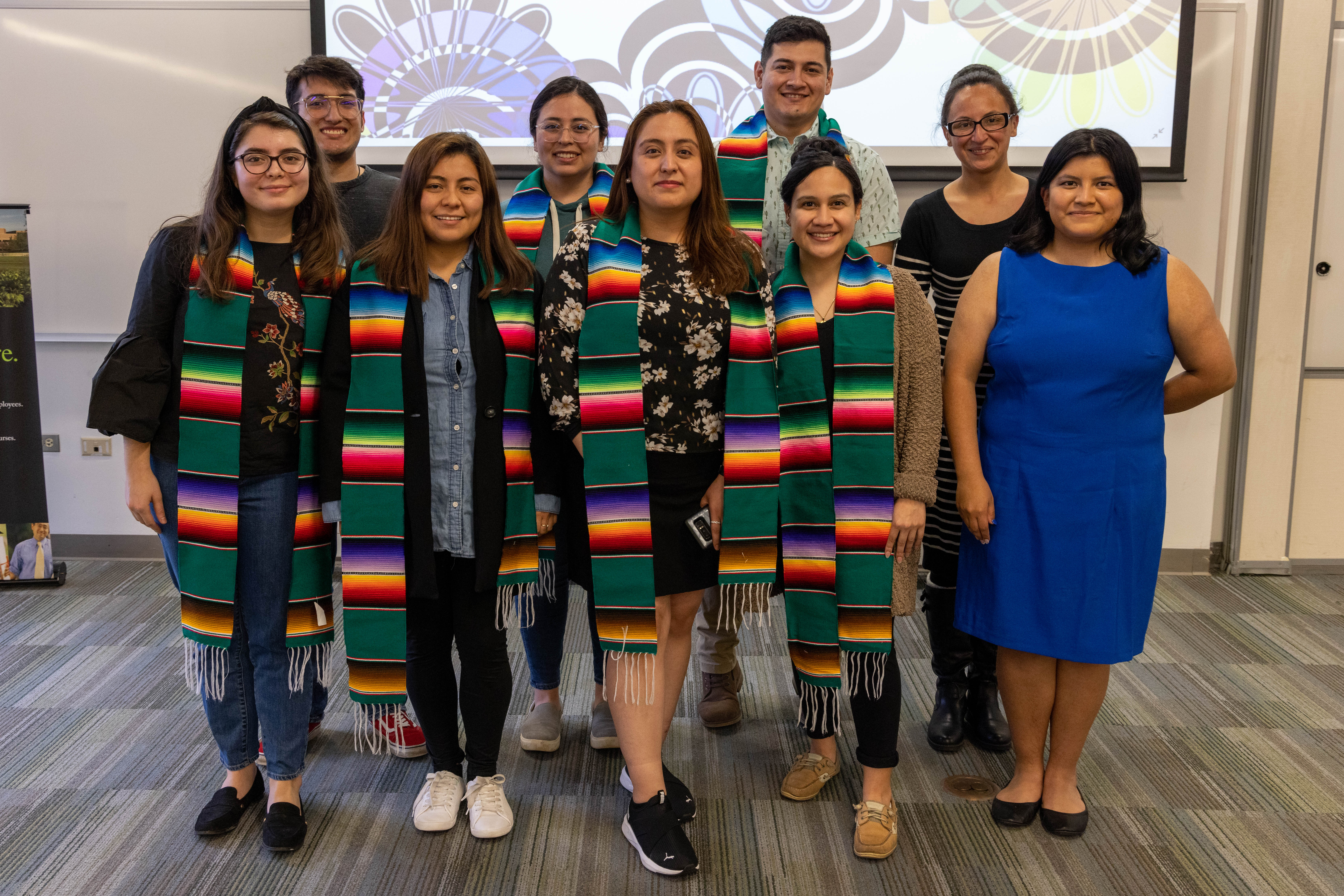 Group of students from Latine club celebrating graduation with special stole.