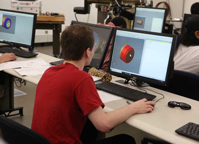 Student using a computer in the manufacturing lab.