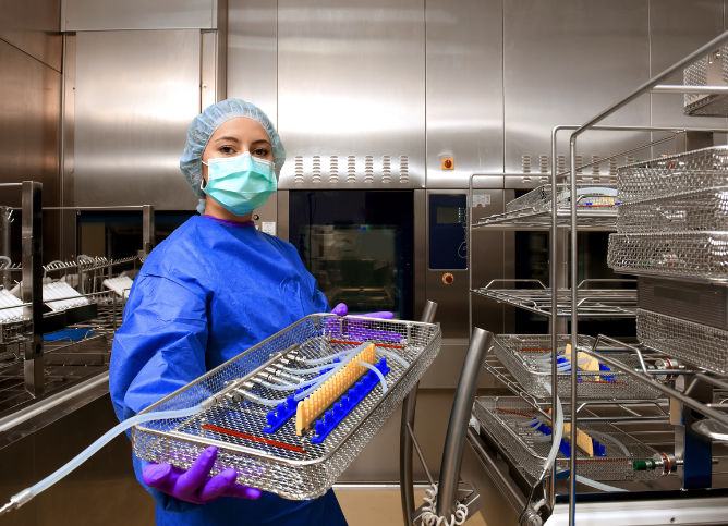 A sterile processor showcases surgical tools in a hospital environment.