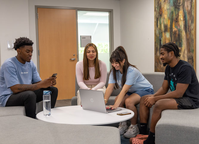 Oakton students sitting around a table together.
