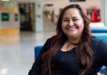 An adult student smiles while sitting on the Des Plaines campus.