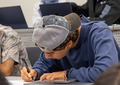 Male student taking a test. 