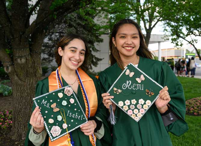Two students wearing cap and gown.